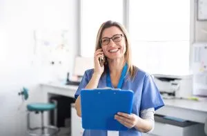 A staff doing a doctor referral by the phone